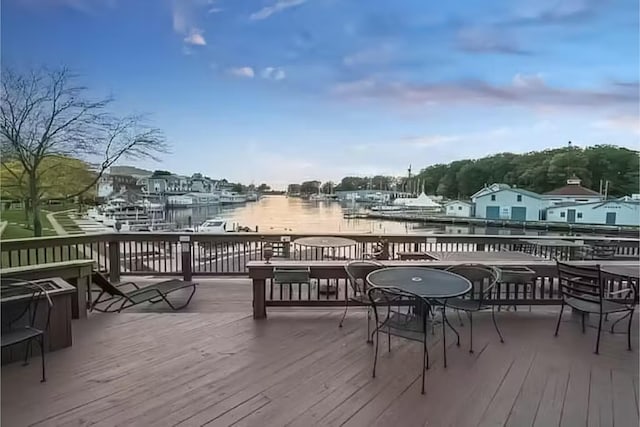 wooden terrace featuring a water view