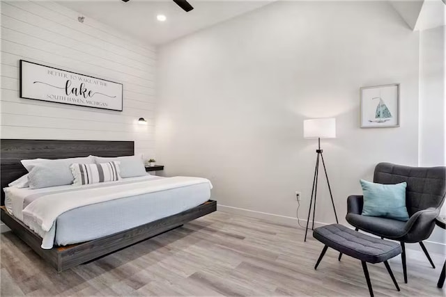 bedroom with light hardwood / wood-style floors and ceiling fan