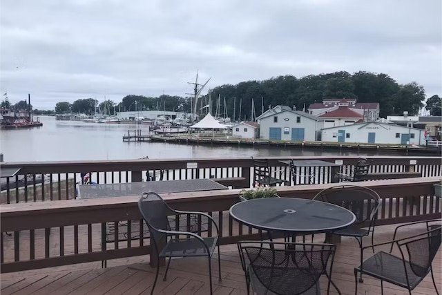 wooden deck with a bar and a water view