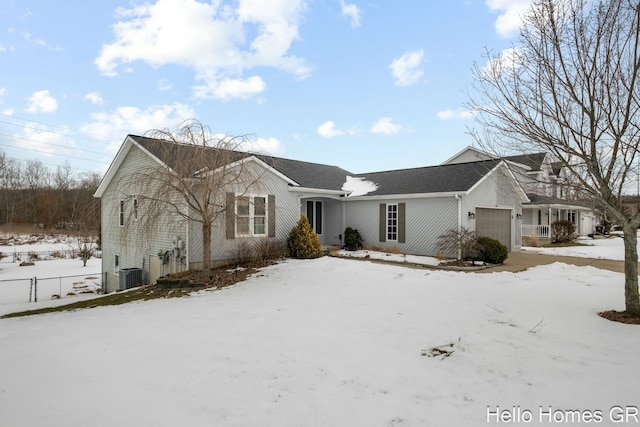 view of front of home featuring a garage and central AC