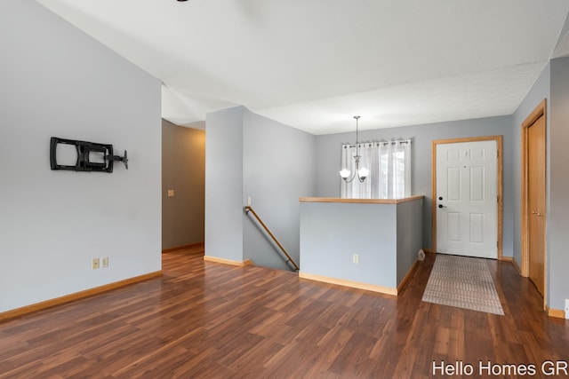 foyer featuring dark hardwood / wood-style floors and a chandelier