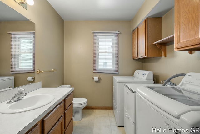 washroom featuring separate washer and dryer, sink, and a wealth of natural light