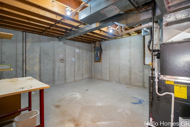 basement featuring heating unit and electric panel