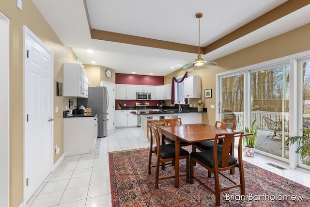 tiled dining space featuring sink