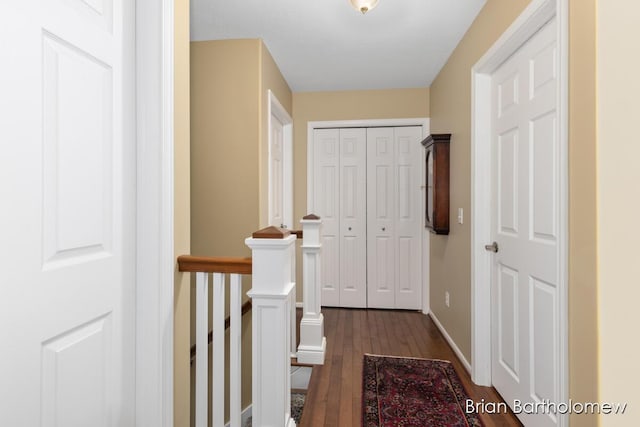 corridor with dark hardwood / wood-style flooring