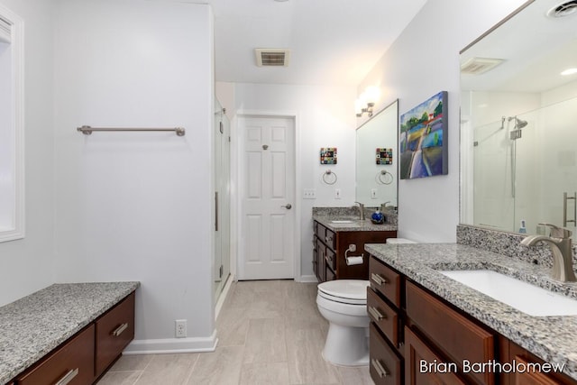 bathroom with walk in shower, vanity, and toilet