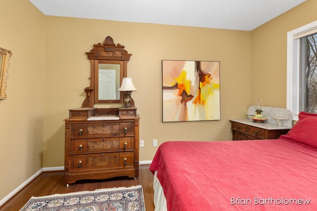 bedroom with dark hardwood / wood-style floors