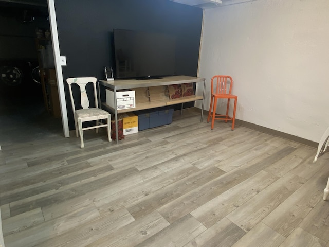 interior space with baseboards and light wood-style floors