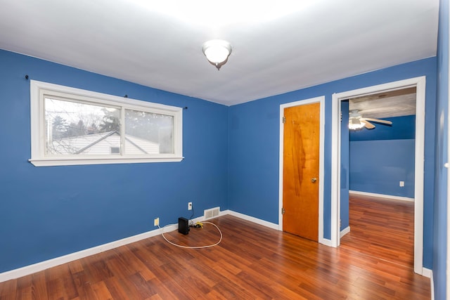 unfurnished bedroom with dark hardwood / wood-style floors