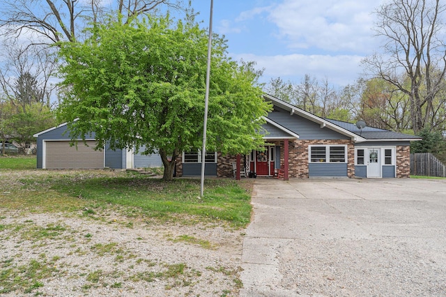 2678 Richmond St NW, Grand Rapids, MI 49504 - view of front of house with fence and brick siding