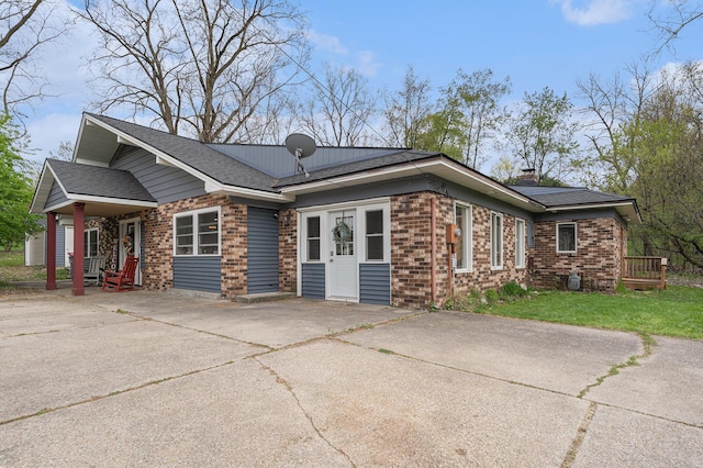 2678 Richmond St NW, Grand Rapids, MI 49504 - view of front of property featuring concrete driveway, brick siding, and a chimney