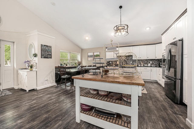 2678 Richmond St NW, Grand Rapids, MI 49504 - kitchen with freestanding refrigerator, decorative backsplash, dark wood-style floors, and white cabinets