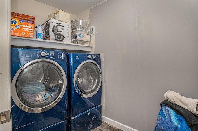 2678 Richmond St NW, Grand Rapids, MI 49504 - clothes washing area featuring baseboards, laundry area, independent washer and dryer, and wood finished floors