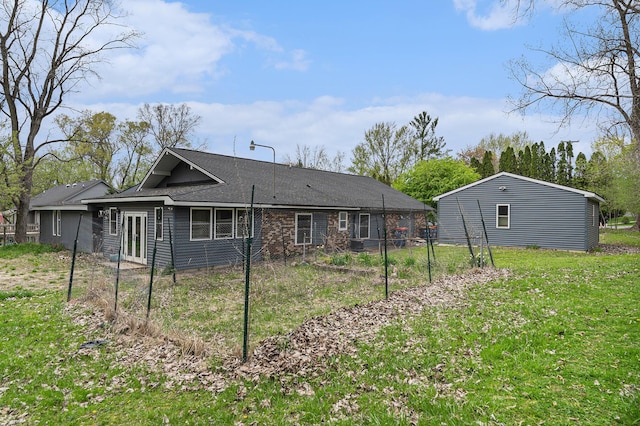 2678 Richmond St NW, Grand Rapids, MI 49504 - rear view of house featuring fence and a lawn