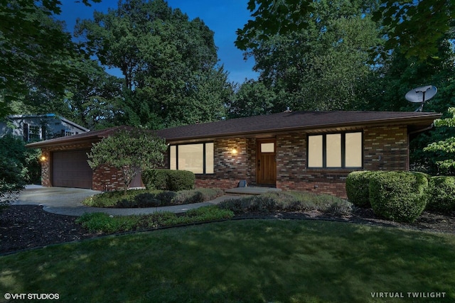 view of front facade with a garage, driveway, a front lawn, and brick siding