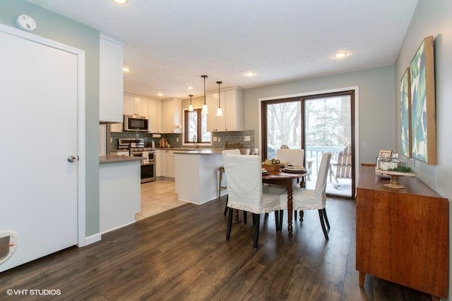 dining room featuring wood finished floors and recessed lighting