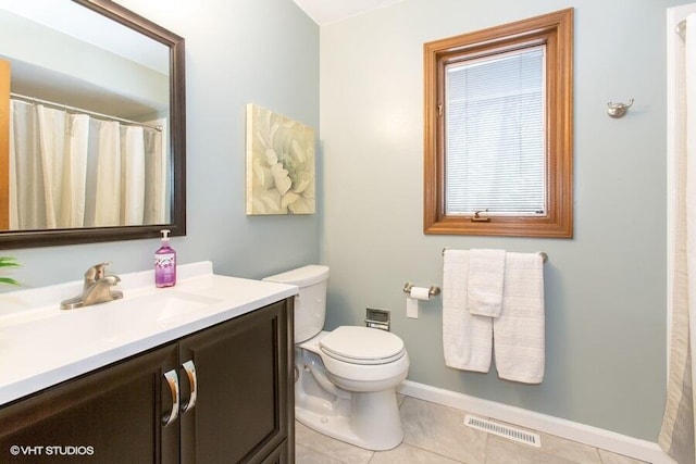 full bathroom featuring toilet, vanity, baseboards, visible vents, and tile patterned floors