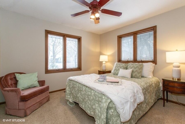 bedroom with light carpet, baseboards, and a ceiling fan