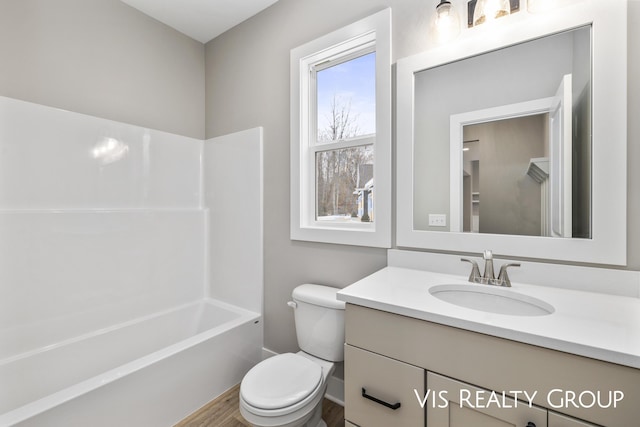 bathroom with toilet, bathtub / shower combination, and vanity