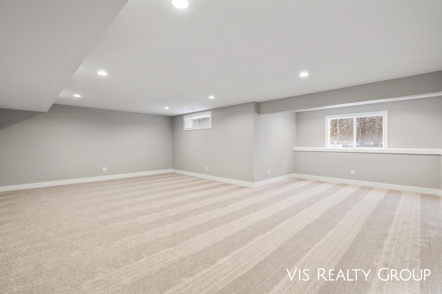 basement featuring recessed lighting, baseboards, and light colored carpet