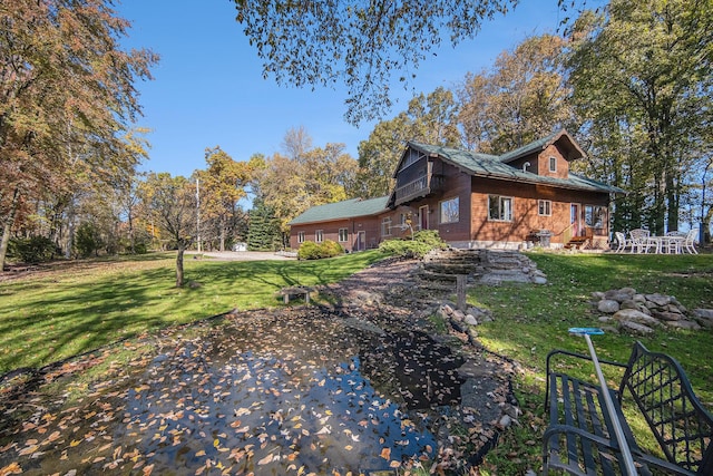 view of side of home with a lawn