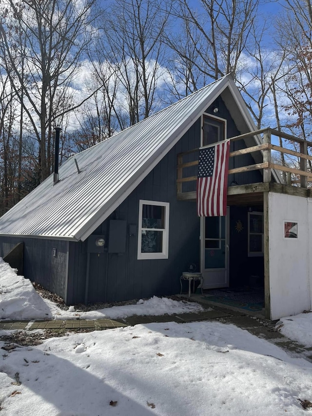 view of snowy exterior with metal roof