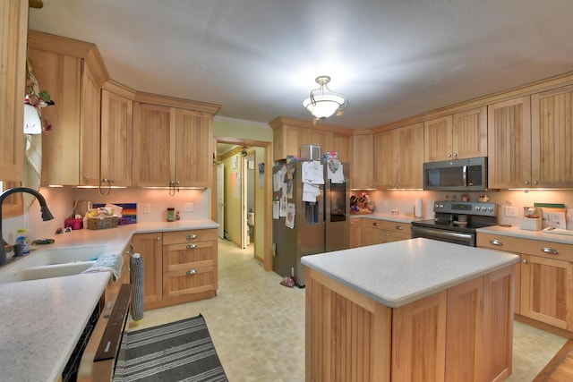 kitchen featuring sink, appliances with stainless steel finishes, light stone counters, a kitchen island, and light brown cabinetry