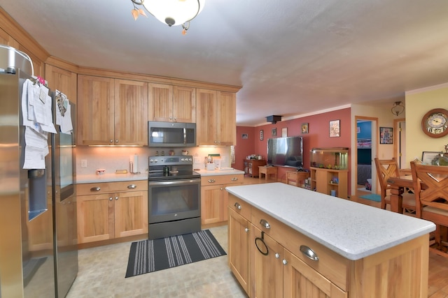 kitchen featuring ornamental molding, appliances with stainless steel finishes, and a center island