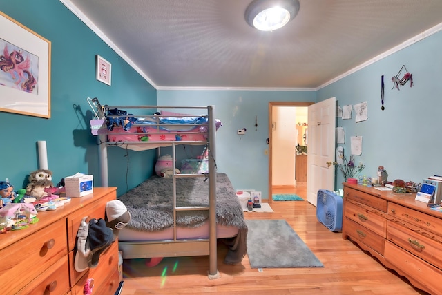 bedroom featuring crown molding and light wood-type flooring