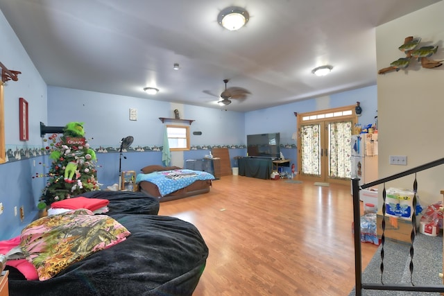 bedroom with french doors and hardwood / wood-style floors