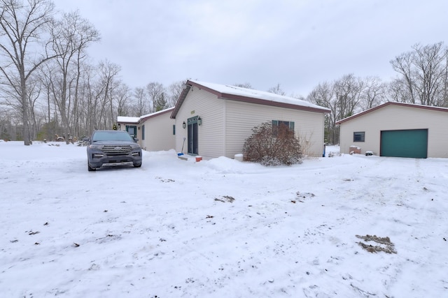 view of snow covered exterior featuring a garage