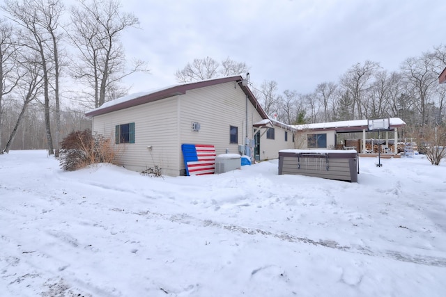 view of snow covered back of property