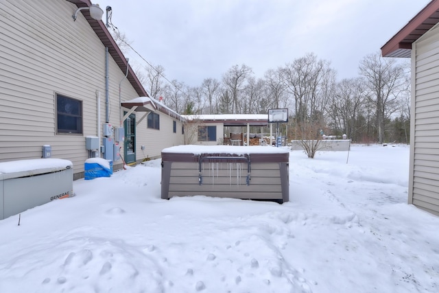 snowy yard with a hot tub