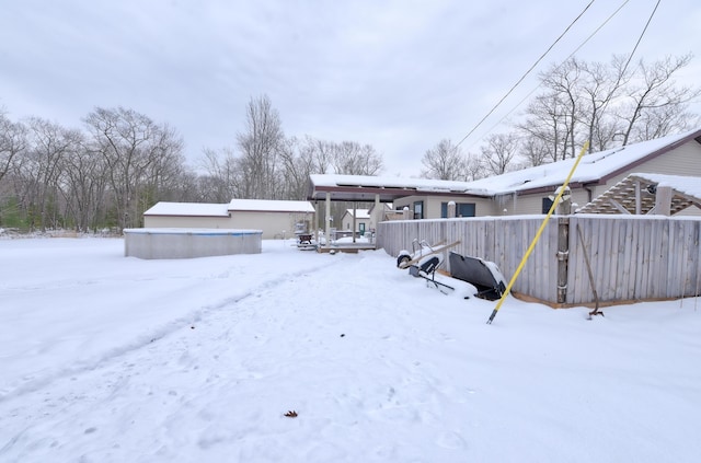 view of snow covered rear of property