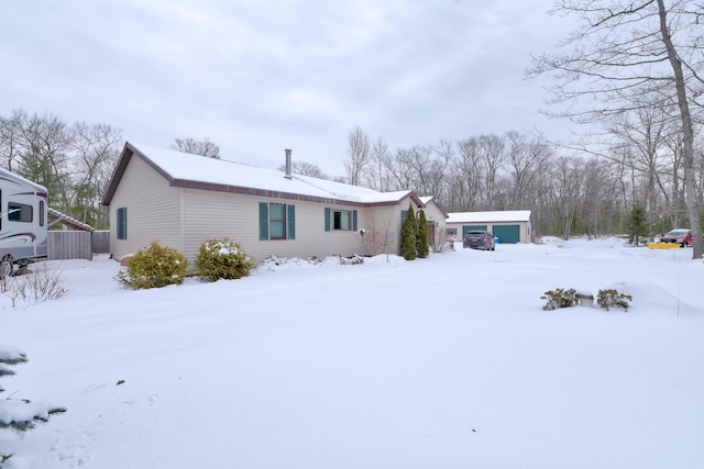 view of snow covered rear of property