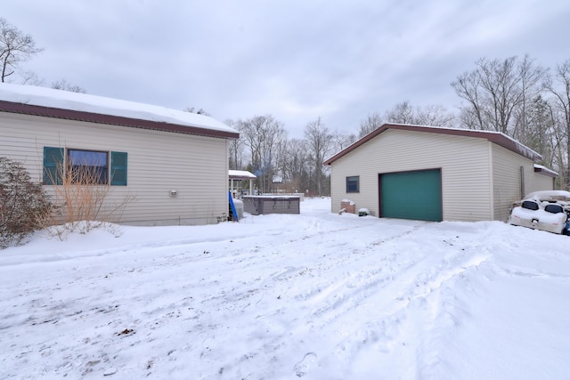 exterior space featuring a garage and an outbuilding