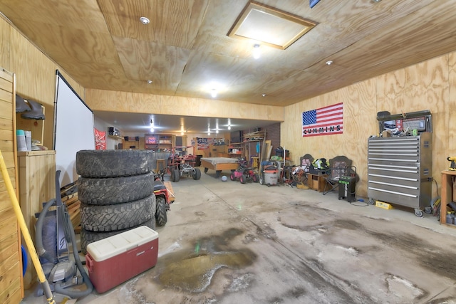 garage with wood ceiling and a workshop area