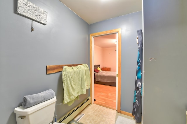 bathroom with toilet and a baseboard heating unit