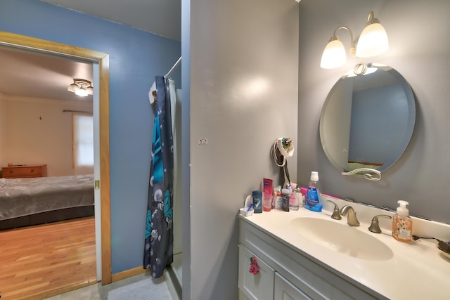 bathroom featuring vanity, hardwood / wood-style floors, and curtained shower