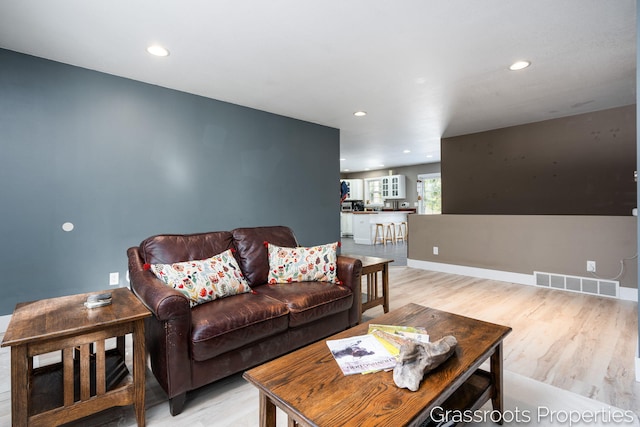 living room with light hardwood / wood-style flooring