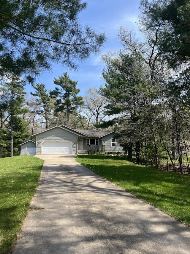 6474 Blackhawk Ln, Twin Lake, MI 49457 - view of front facade with a front yard, driveway, and a garage