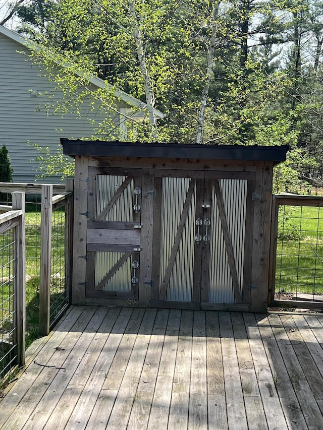 6474 Blackhawk Ln, Twin Lake, MI 49457 - wooden deck featuring a storage unit and an outbuilding