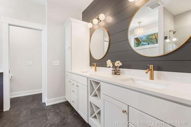 bathroom with vanity and wood walls