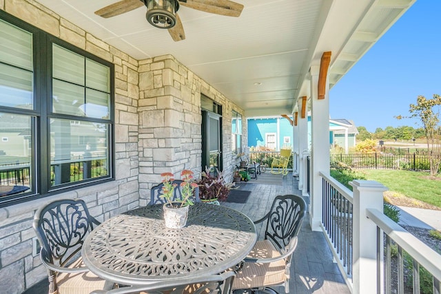 view of patio with covered porch, fence, and a ceiling fan