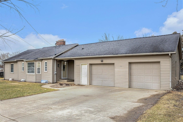 ranch-style house featuring a garage and a front yard