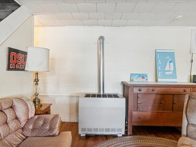 sitting room with heating unit and dark hardwood / wood-style flooring