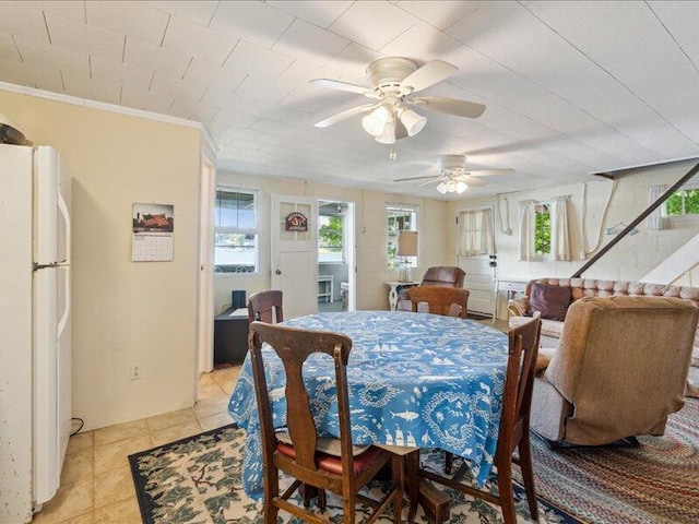 dining area with ornamental molding and light tile patterned floors