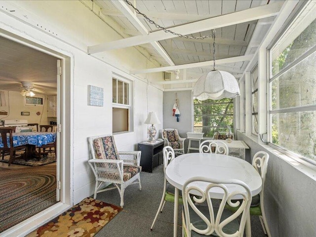 sunroom with beam ceiling, wooden ceiling, and ceiling fan