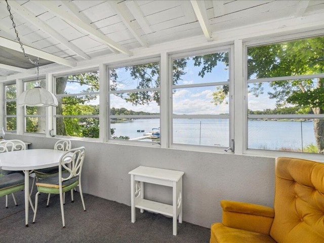 sunroom with a water view, wood ceiling, and beamed ceiling