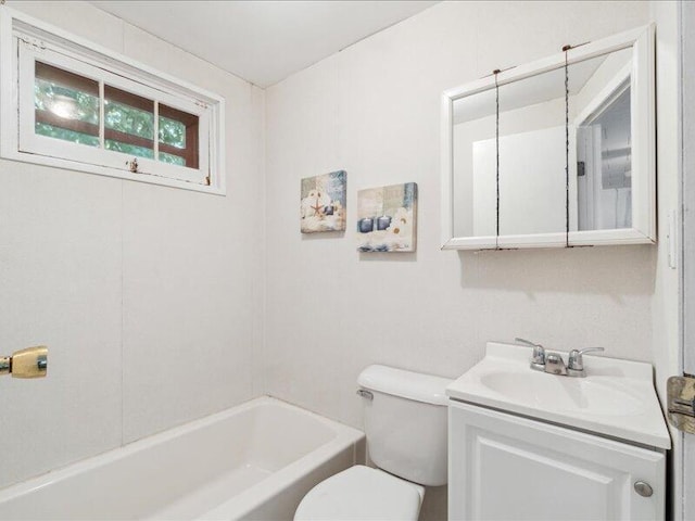 bathroom featuring vanity, a bathtub, and toilet